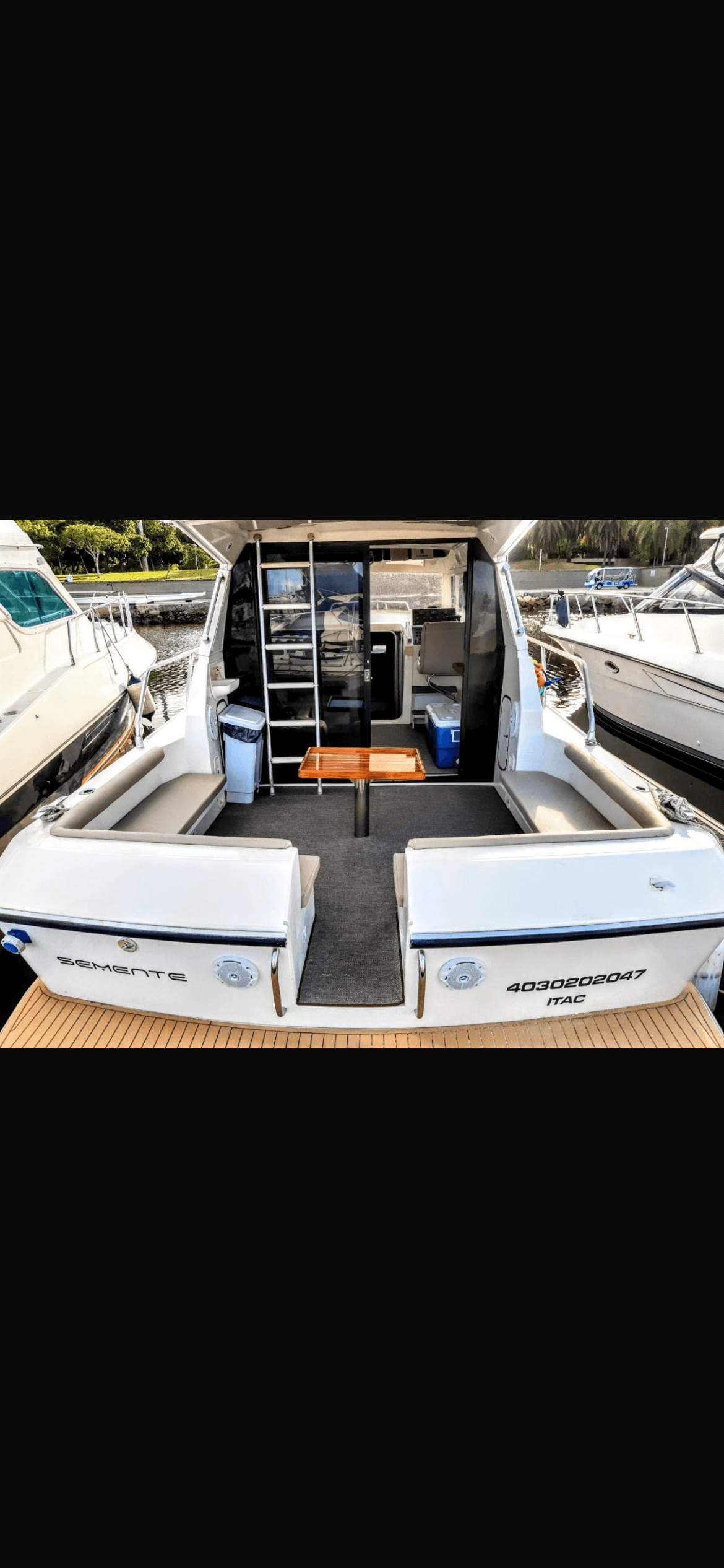 Oceanic 36 rear deck with seating areas and wooden table