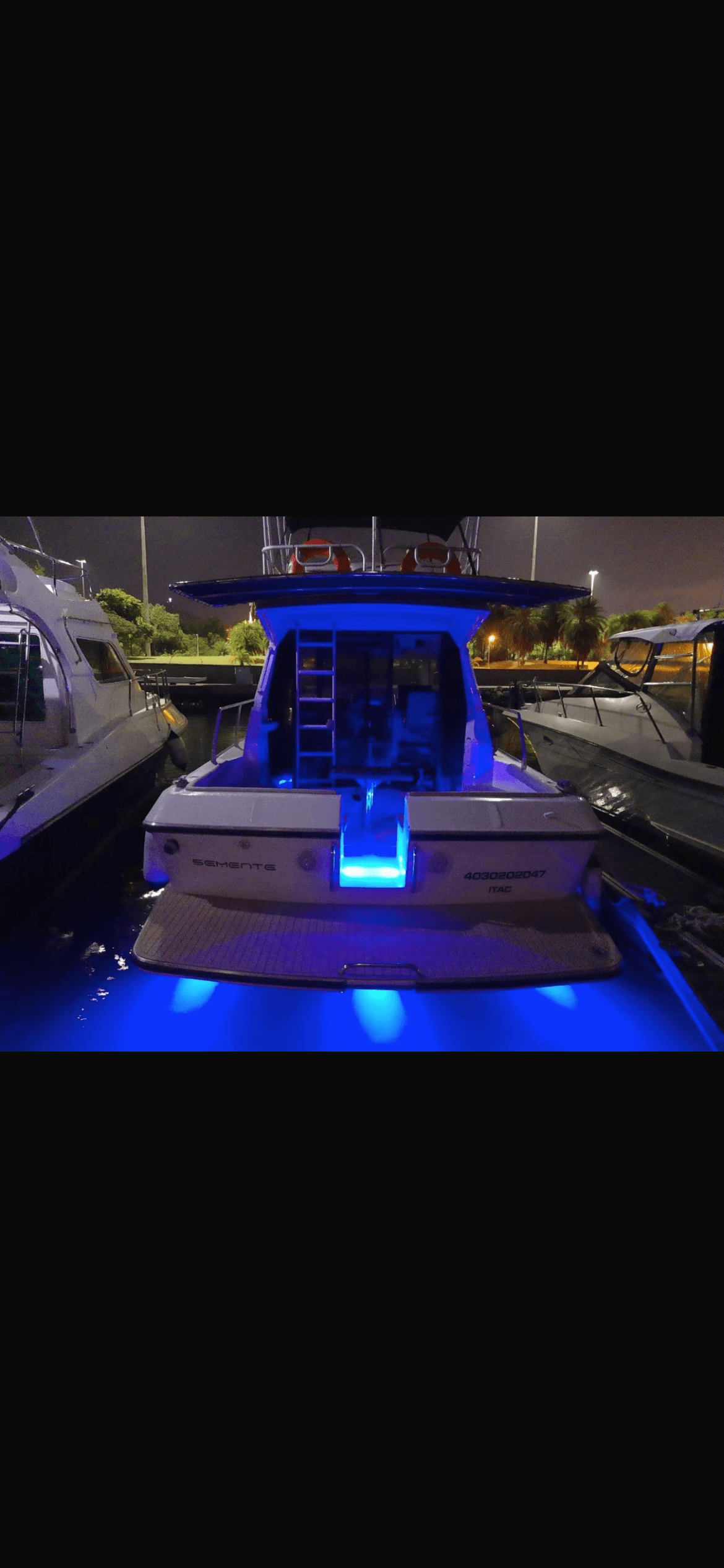 Oceanic 36 at night with blue LED lighting illuminating the deck