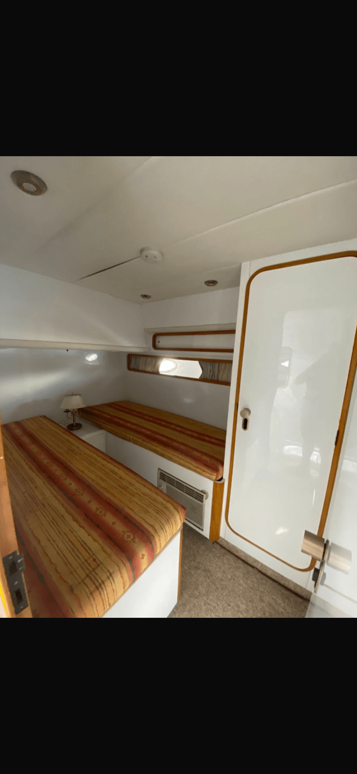 Aquarius 60 cabin with twin beds and striped bedding