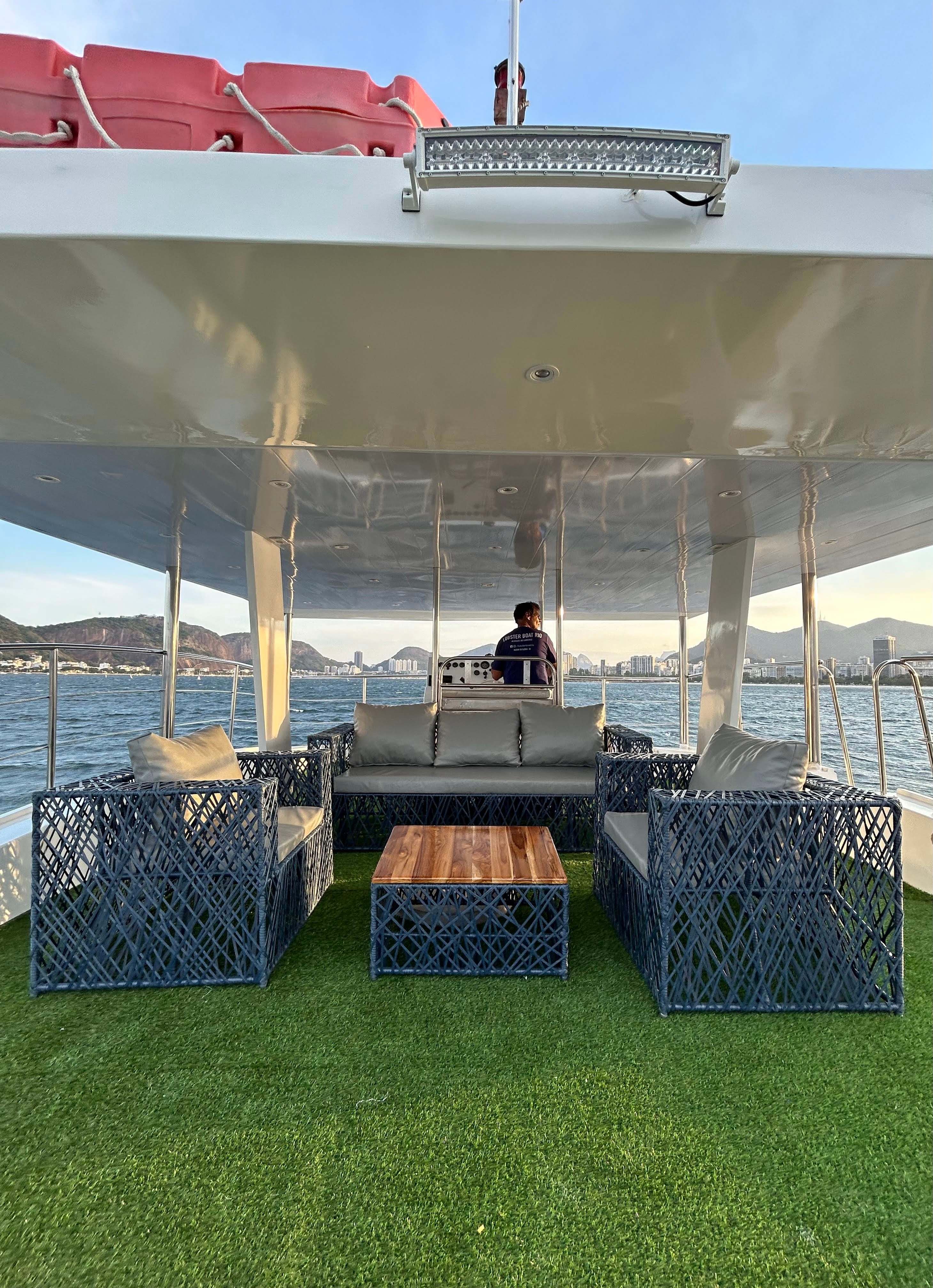 Oceano upper deck lounge area with seating and view of Rio