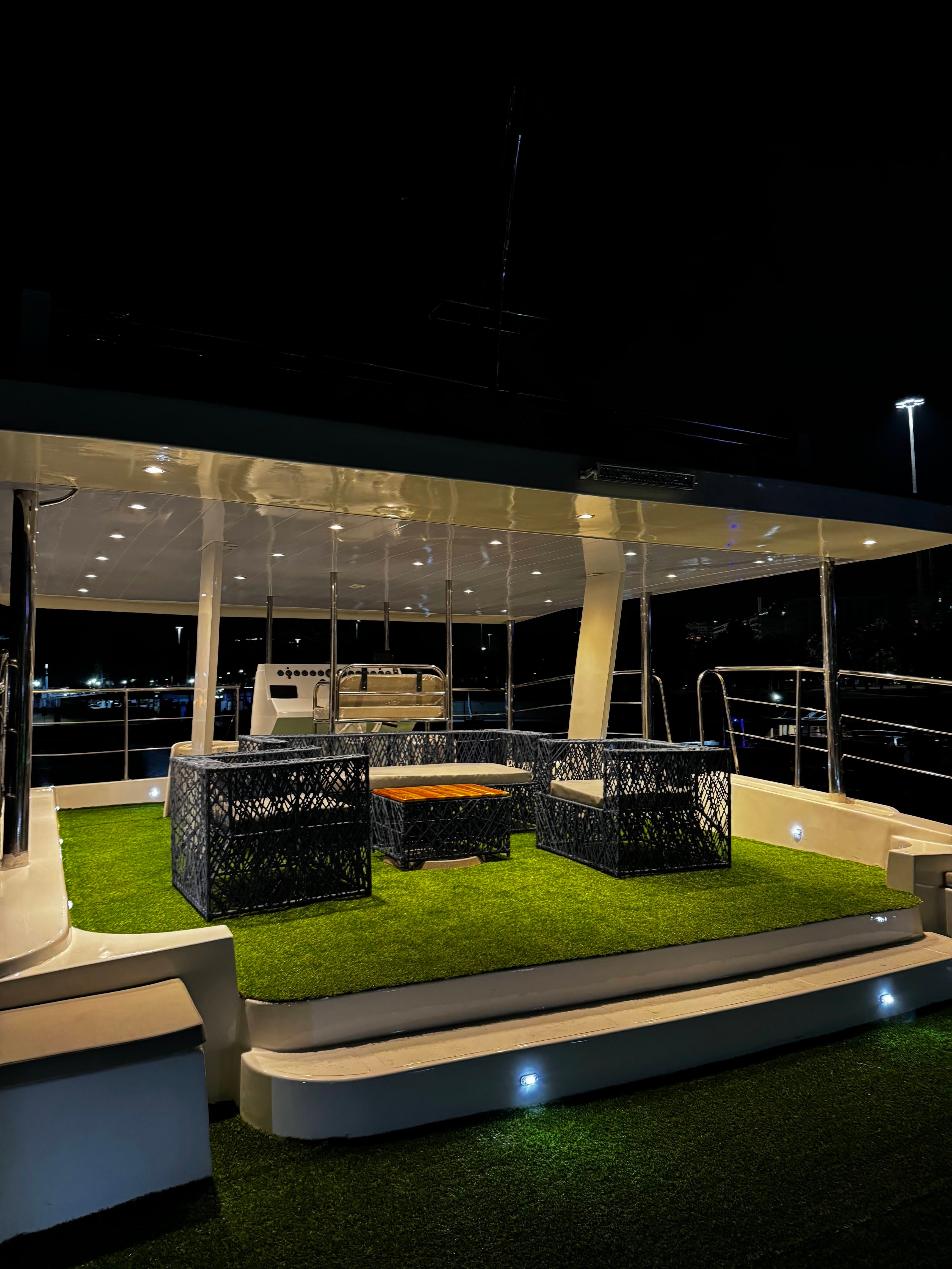 Oceano upper deck lounge area at night with lighting