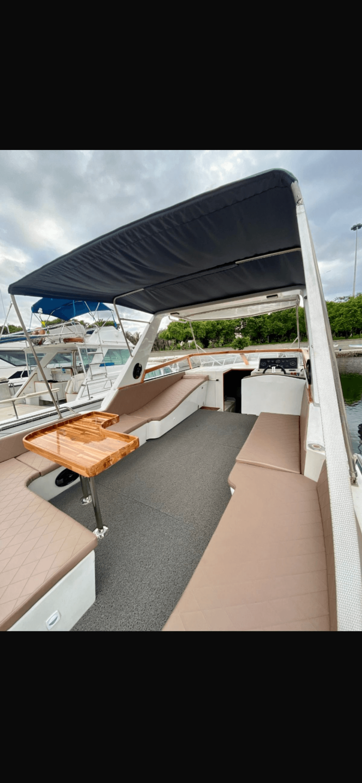 Rival 36 deck area with canopy, seating and wooden table